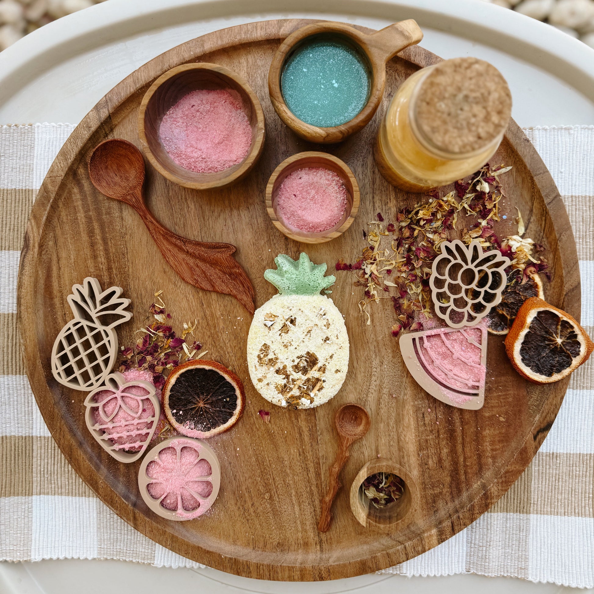 Wooden sensory table with colorful play fizz, dried flowers and wooden tools, for child development and emotional regulation.