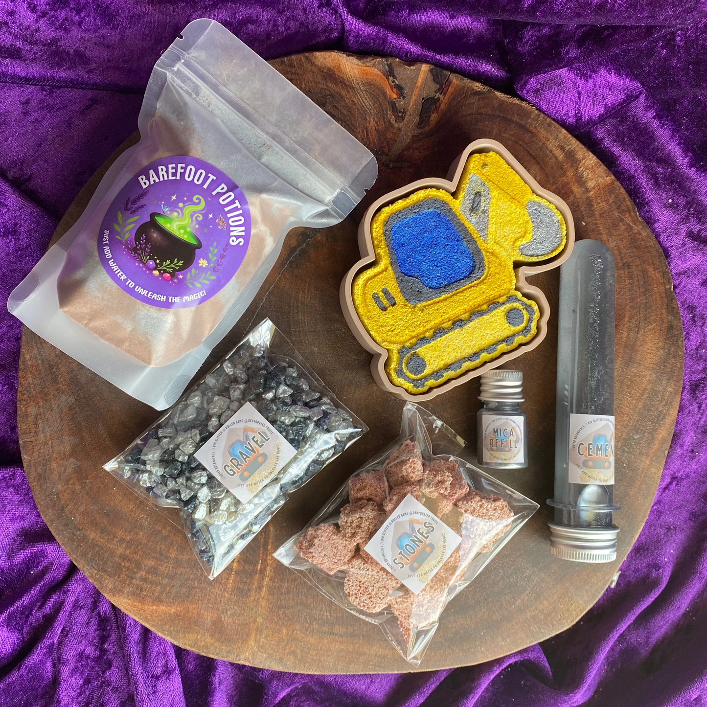 Construction Potion Kit layed out showing all elements from the digger 3D printed tray, digger fizzer fizzer stones, Gravel shimmer rocks, a bag of digger dirt fizzy potion, cement water activator & Mica Refill Jar.
Sensory bin
sensory play
potion kit
potion play
diggers lover
boys toys and sensory 
fizzy play 