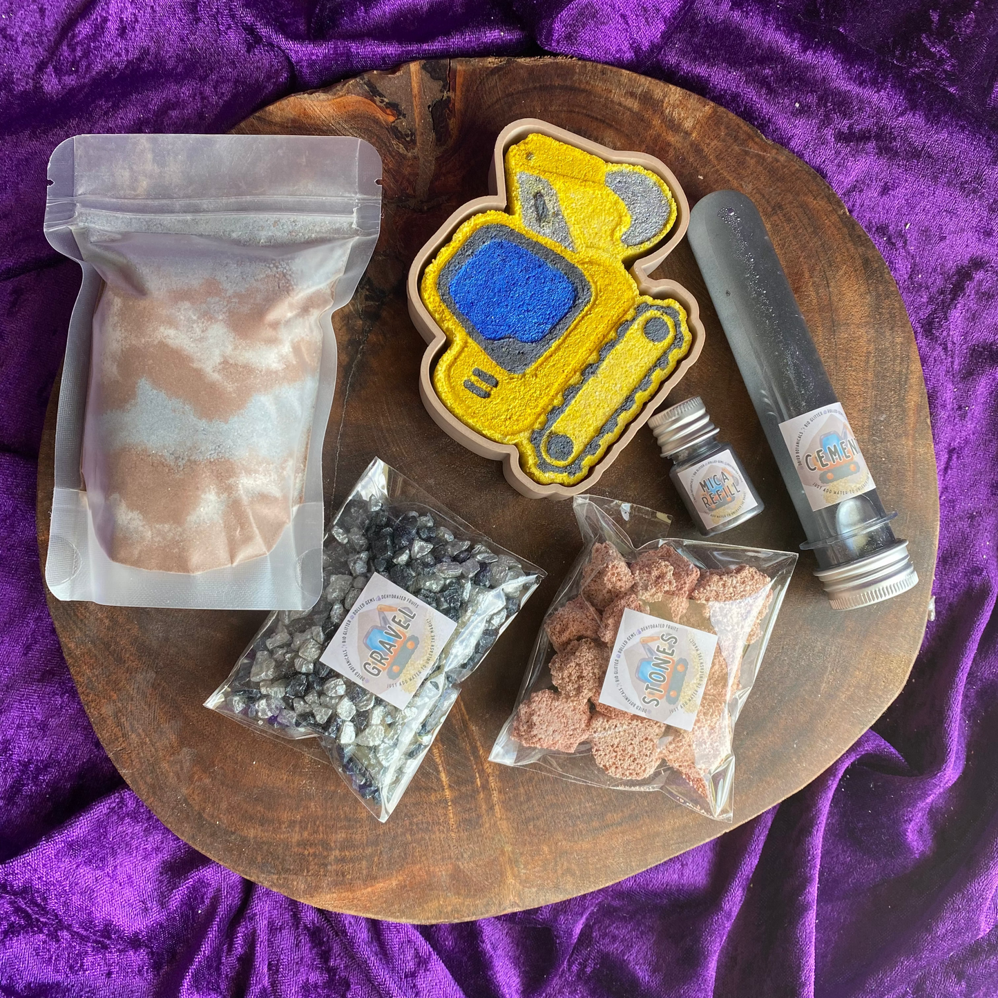 Construction Potion Kit layed out showing all elements from the digger 3D printed tray, digger fizzer fizzer stones, Gravel shimmer rocks, a bag of digger dirt fizzy potion, cement water activator & Mica Refill Jar.
Sensory bin
sensory play
potion kit
potion play
diggers lover
boys toys and sensory 