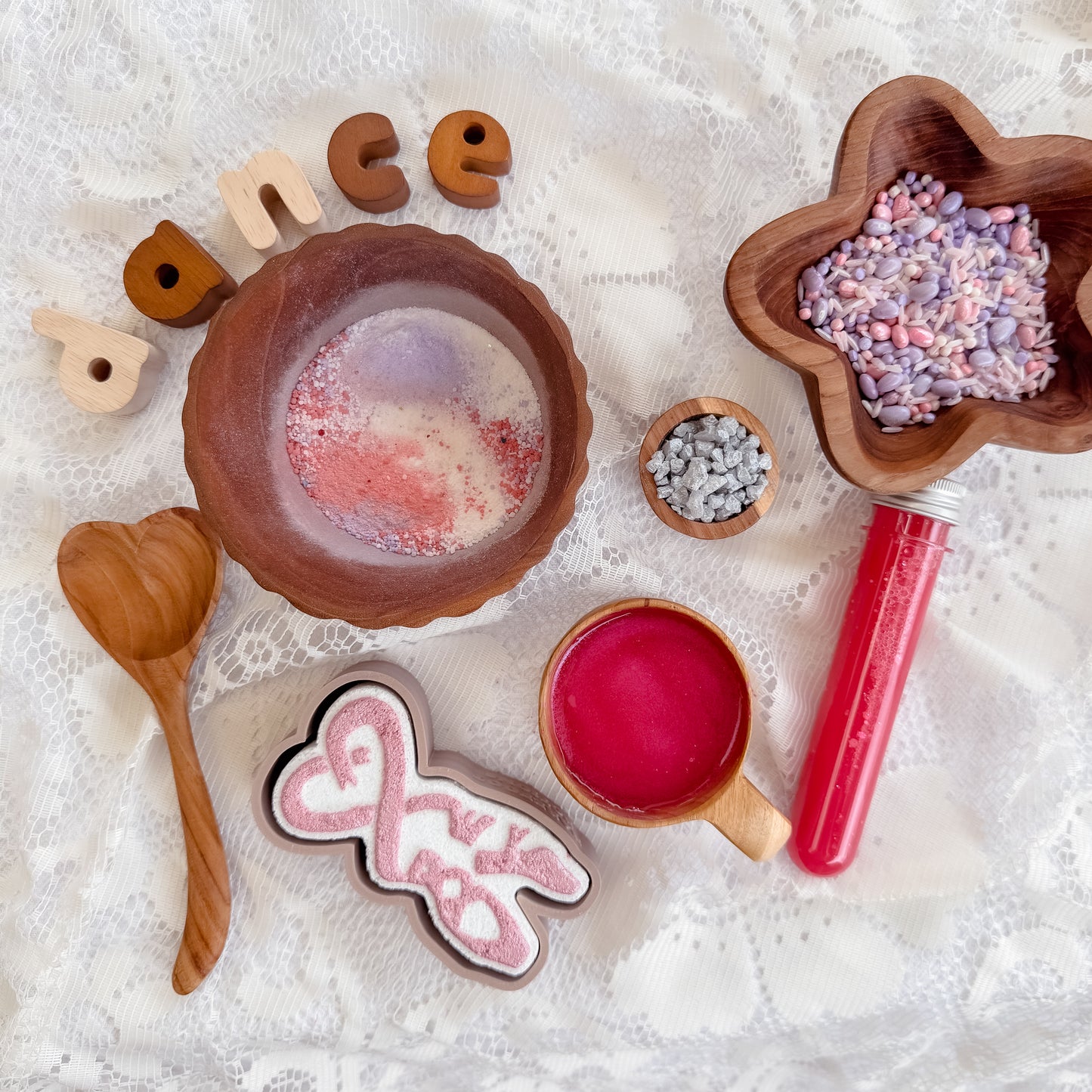 Ballerina themed sensory play for kids, silver shimmer rocks, pink potion, fizz purple and white sensory bin base, wooden heart spoon, bubble and star bowl. Ballet dance activity. 