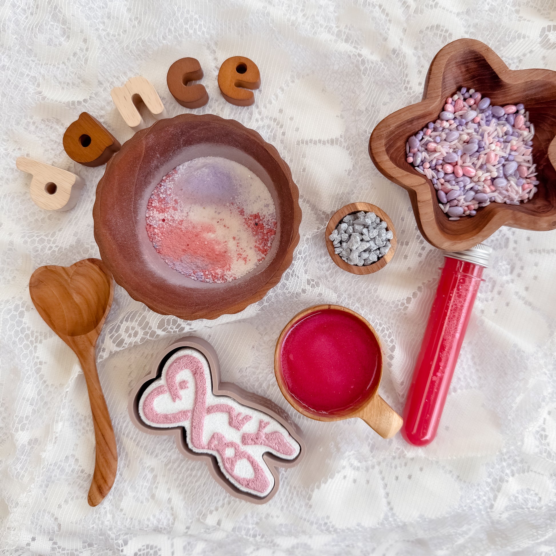 Ballerina themed sensory play for kids, silver shimmer rocks, pink potion, fizz purple and white sensory bin base, wooden heart spoon, bubble and star bowl. Ballet dance activity. 