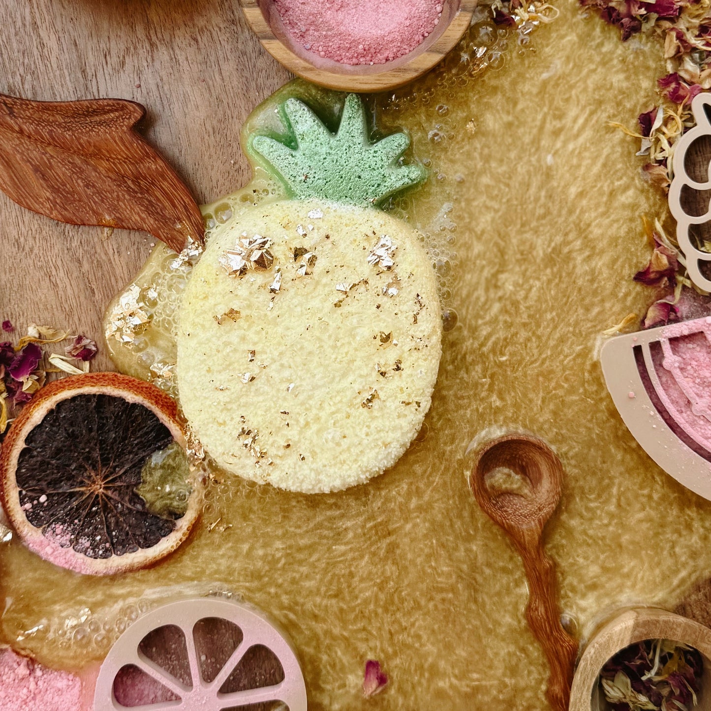 Wooden sensory table with colorful play fizz, dried flowers and wooden tools, for child development and emotional regulation. 